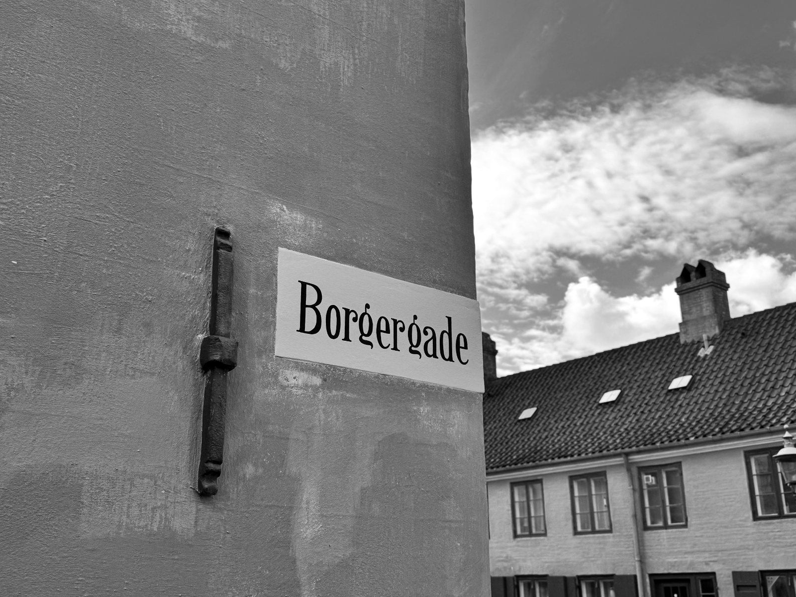 Borgergade street sign on a gable — black and white